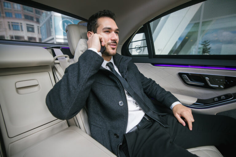 | X Chauffeurs | X Chauffeurs Businessman Enjoying Comfortable Ride in Luxury Car Interior